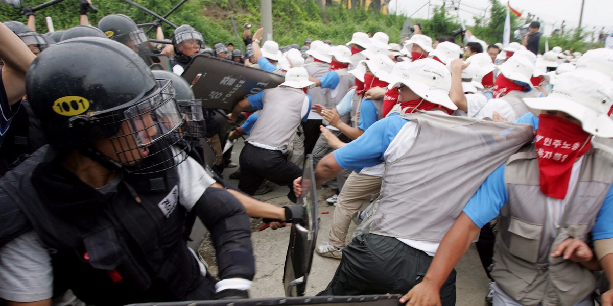 South Korean police use shields and clubs to stop protesters trying to enter the U.S. army's Camp Humphreys in Pyongtaek, about 80 km (50 miles) south of Seoul, August 8, 2005.