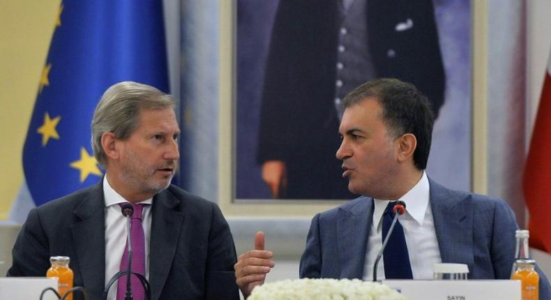 Turkish EU affairs minister, Omer Celik, seen with EU enlargement commissioner Johannes Hahn, blasted EU lawmakers' vote to freeze accession talks as a politically motivated decision which was sabotaging relations