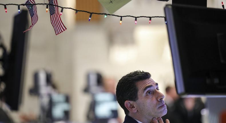 A trader works at his desk ahead of the closing bell on the floor of the New York Stock Exchange (NYSE), December 17, 2018 in New York City.