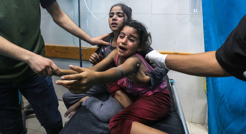 Children injured in an Israeli air strike react as they receive treatment in the Nasser hospital in Khan Yunis in the southern of Gaza Strip, on October 17, 2023.MAHMUD HAMS/AFP via Getty Images