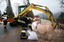 Strażacy układają worki z piaskiem, zabezpieczając zalaną drogę w rejonie Witowa, po ulewnych deszczach na Podhalu