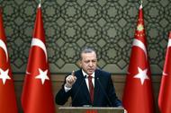 Turkish President Tayyip Erdogan makes a speech during his meeting with mukhtars at the Presidential