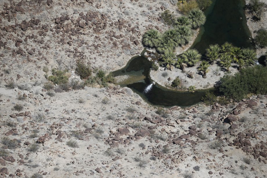 Water flows into a dried-out lake on a golf course in La Quinta.