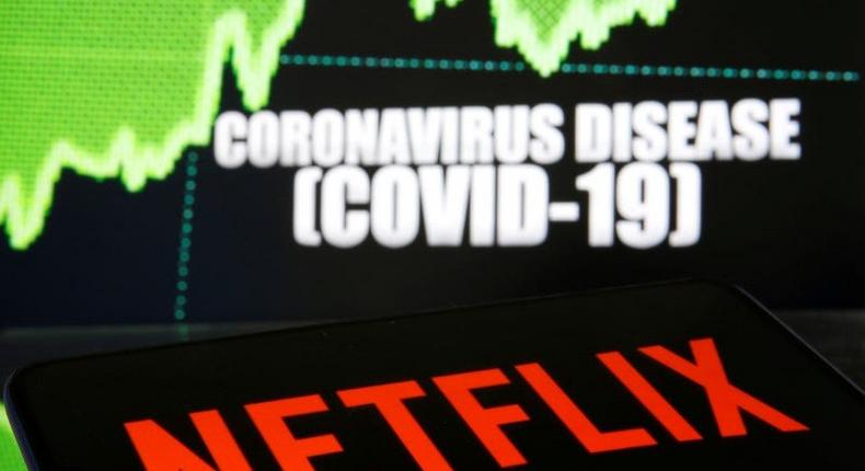 FILE PHOTO: Netflix logo is seen in front of diplayed coronavirus disease (COVID-19) in this illustration taken March 19, 2020. REUTERS/Dado Ruvic/Illustration