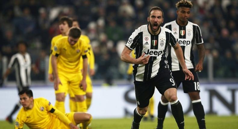 Juventus' forward Gonzalo Higuain celebrates after scoring during the UEFA Champions League football match Juventus Vs GNK Dinamo Zagreb on December 7, 2016 at the 'Juventus Stadium' in Turin