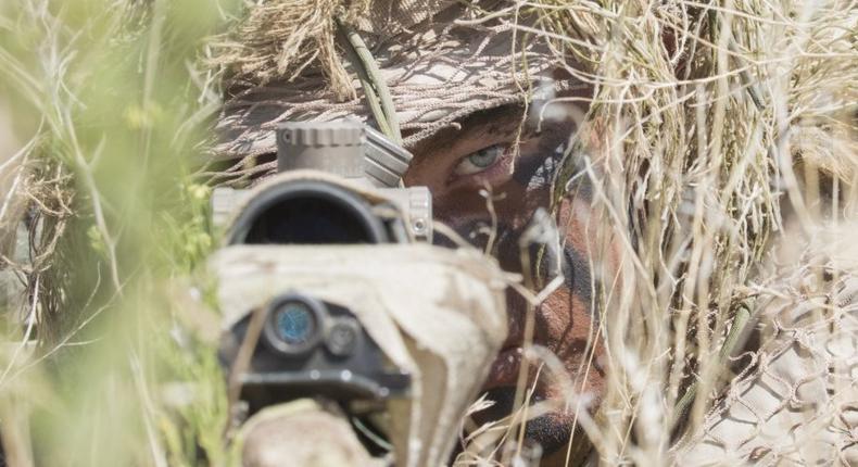 Hidden beneath twigs and weeds, a snipers stomach is flat on the ground, dirt and grime on his face. All that can be seen in the bundles of cheatgrass is a pair of steady, intense eyes.