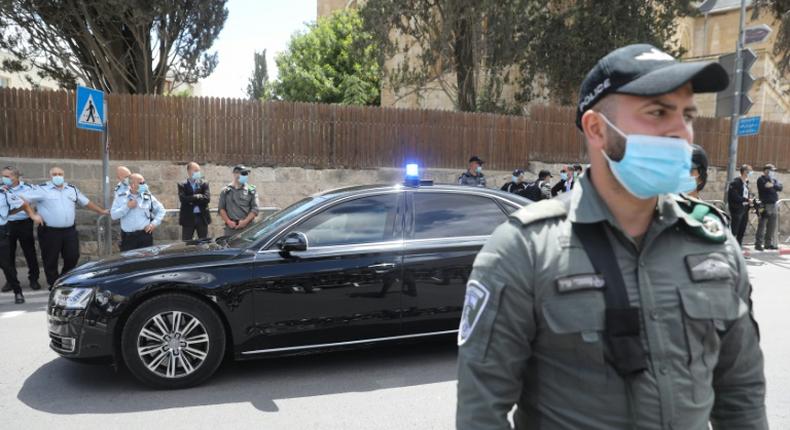 Israeli soldiers stand guard as Prime Minister Benjamin Netanyahu's motorcade arrives at the Jerusalem courthouse for his much-delayed corruption trial