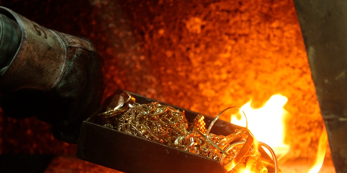 A worker places gold jewelry into a melting furnace at the Austrian Gold and Silver Separating Plant "Oegussa" in Vienna on October 23, 2012.