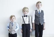 Brothers wearing suits indoors