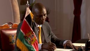 President William Ruto signs a document at State House