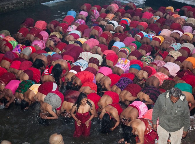 Kobiety uczestniczą w rytualnej kąpieli w rzece Salinadi w czasie obchodów święta Madhav Narayan w Sankhu, starożytnej wiosce niedaleko Katmandu
