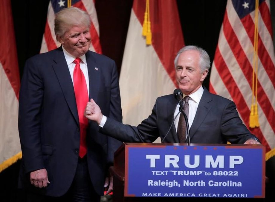 Republican U.S. presidential candidate Donald Trump listens as Senator Bob Corker (R-TN) speaks at a campaign rally in Raleigh