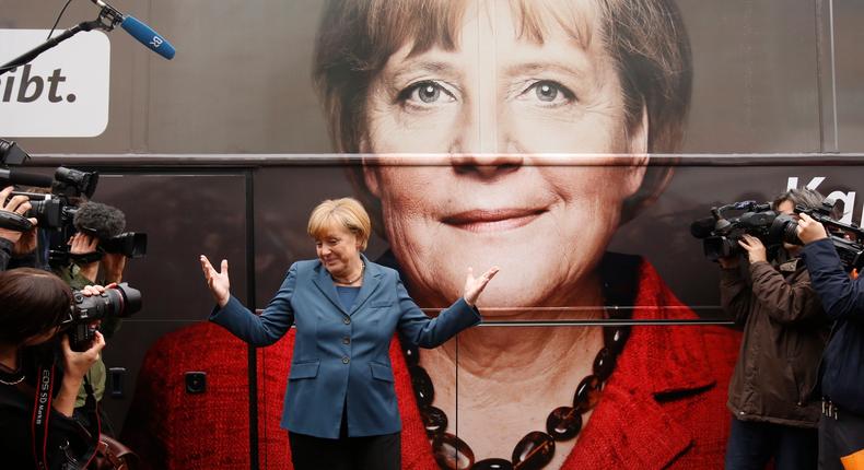 German Chancellor Angela Merkel stands in front of her election-campaign tour bus before a meeting in Berlin on September 16, 2013.