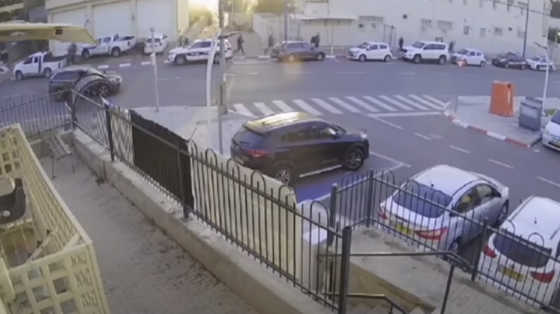 Terroryści podchodzą pod posterunek policji (w głębi), po lewej stronie widać pick-upa Hamasu.
