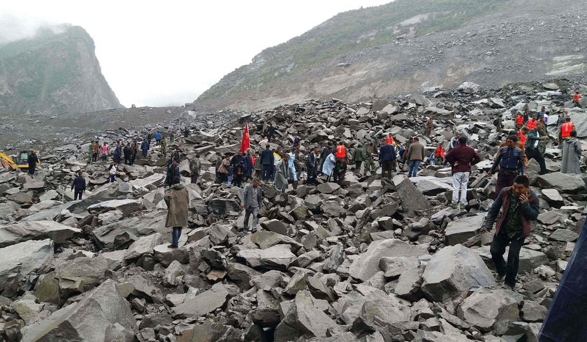 People search for survivors at the site of a landslide that occurred in Xinmo Village