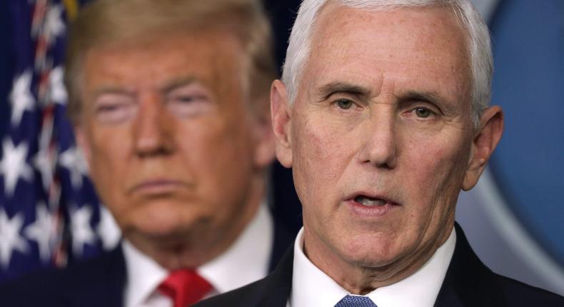 President Donald Trump listens as Vice President Mike Pence speaks at a coronavirus briefing in February 2020.
