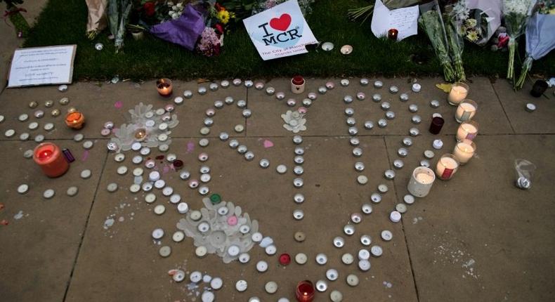 Floral tributes, messages and candles are left in Manchester in tribute to the victims of Monday's attack at a concert venue in the city