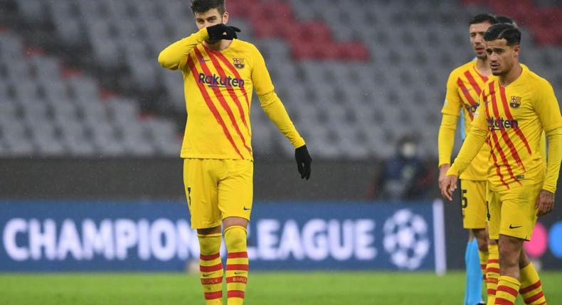 Gerard Pique (L) and Philippe Coutinho at the end of Barcelona's 3-0 defeat at the hands of Bayern Munich that sent them packing from the Champions League Creator: Christof STACHE