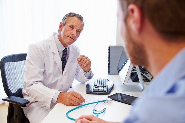 Male Patient Having Consultation With Doctor In Office