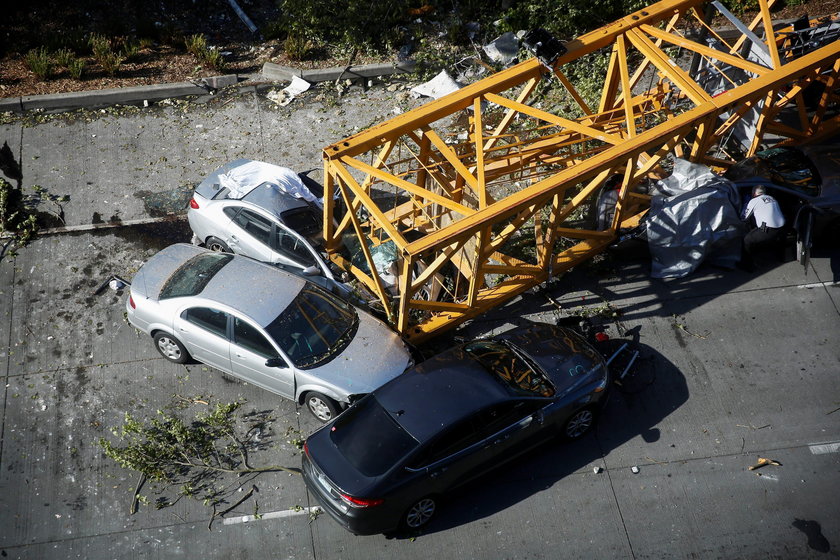 Part of a construction crane that fell in a deadly accident is removed from the scene on Mercer Stre