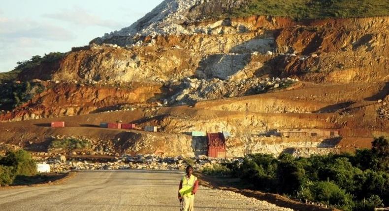 A Malagasy worker walks along an access track at mining giant Rio Tinto's project to construct an ilmenite (iron titanium oxide) mine in Fort Dauphin on Madagascar's south-eastern coast in this file photo. REUTERS/Ed Harris/Files