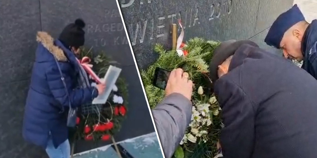 Anita Czerwińska i Marek Suski usuwają kontrowersyjny napis na wieńcu przy pomniku smoleńskim.