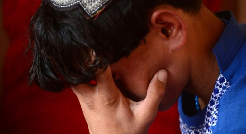 An Afghan boy, who was held as a child sex slave, sits at a restaurant in a unidentified location in Afghanistan