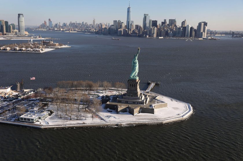 A sign announcing the closure of the Statue of Liberty, due to the U.S. government shutdown, sits ne