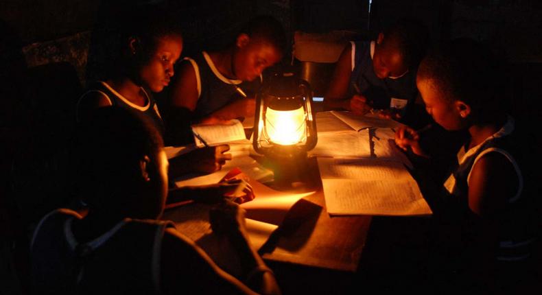 Image of student reading with lantern (file photo)