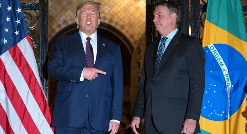 US President Donald Trump (L) and Brazilian President Jair Bolsonaro, pictured here during a dinner at Mar-a-Lago in Palm Beach, Florida, have been kindred spirits in their approaches to the coronavirus pandemic