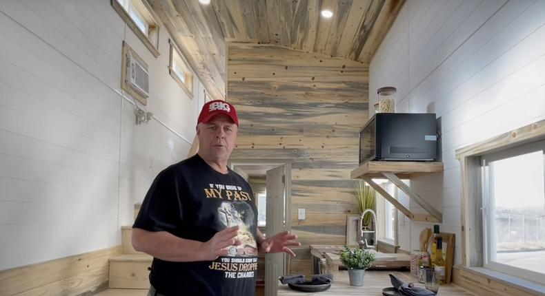 Matt Sowash inside one of his tiny homes.Holy Ground Tiny Homes Youtube channel