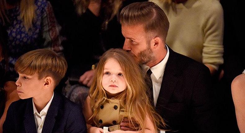David Beckham kisses her daughter; Harper's hair during the show