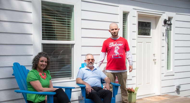 Todd Kuchta (center) and his wife and son stand outside their ADU.Villa/Nicholas Miller