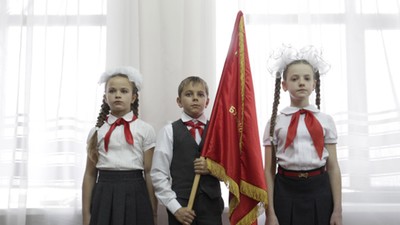 Children attend a ceremony for the inauguration of new members of the Pioneer Organization in Stavro