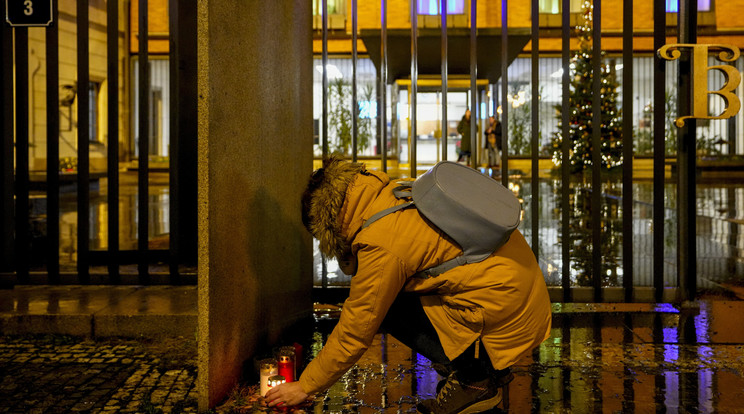 Mécsest gyújt egy nő a prágai Károly Egyetem filozófia intézeténél, a Jan Palach téren elkövetett lövöldözés helyszínén / Fotó: MTI/AP/Petr David Josek