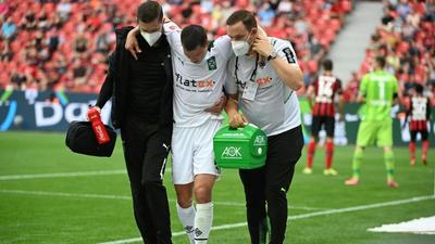 Moenchengladbach defender Stefan Lainer (C) suffered a broken leg in the defeat at Bayer Leverkusen Creator: Ina Fassbender