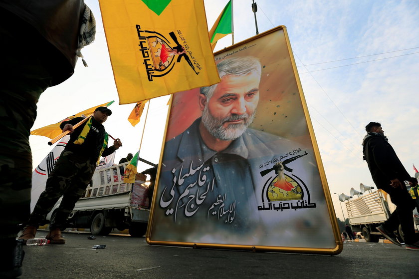 Kataib Hezbollah Iraqi militia hold the picture of the Iranian Major-General Qassem Soleimani, as th