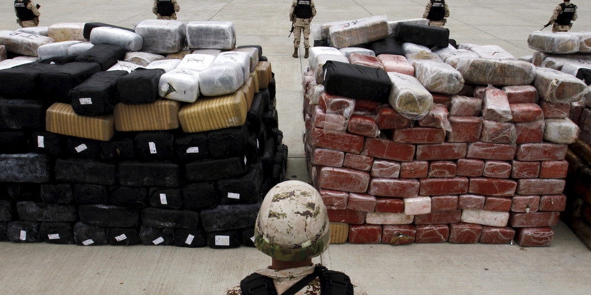 Soldiers stand guard next to packages of marijuana at the 28th Infantry Battalion in Tijuana, Mexico June 13.
