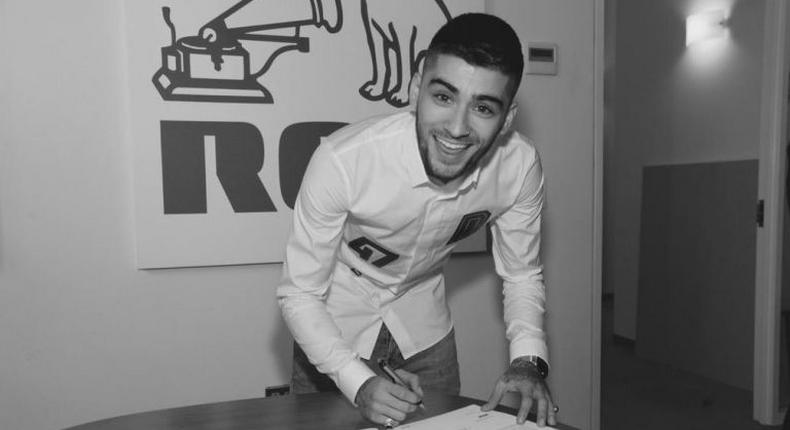 Zayn tweeted this photo of him signing a new deal with RCA