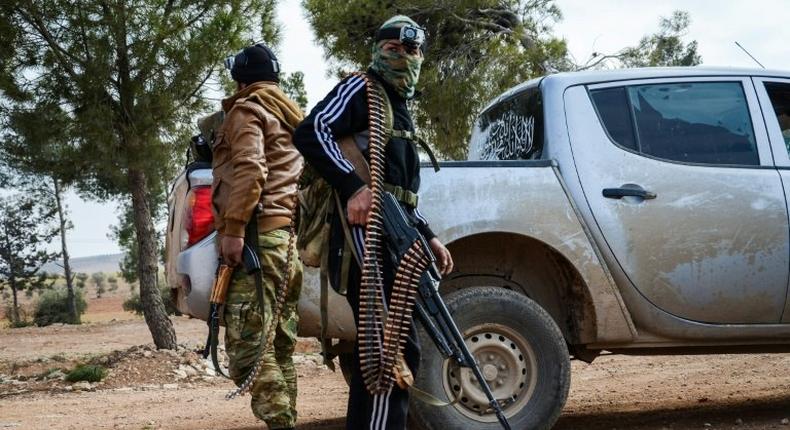 Two fighters from the Free Syrian Army stand guard on February 4, 2017 near the town of Bizaah northeast of the city of Al-Bab where Islamic State is reportedly 'besieged'