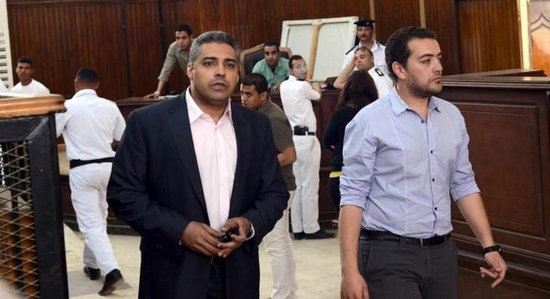 Al-Jazeera television journalists Mohamed Fahmy (L) and Baher Mohamed are seen at a court in Cairo after their retrial, April 22, 2015. REUTERS/Shadi Bushra