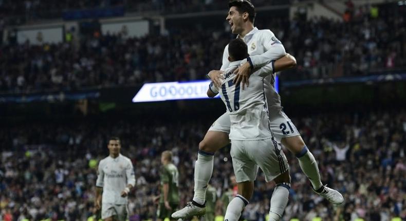 Real Madrid's Lucas Vazquez (L) and Alvaro Morata celebrate after scoring a goal against Legia Warszawa at the Santiago Bernabeu stadium in Madrid on October 18, 2016