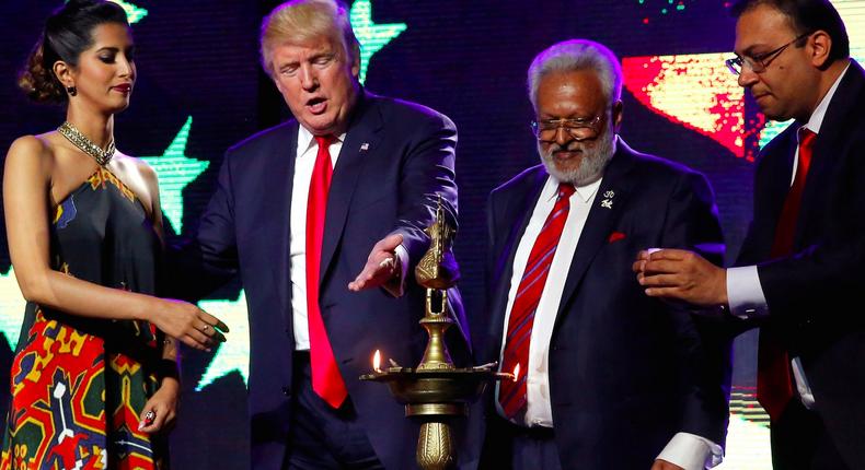 Donald Trump (2nd L) enlists the help of Republican Hindu Coalition Chairman Shalli Kumar (2nd R) and others to light a ceremonial diya lamp before he speaks at a Bollywood-themed charity concert put on by the Republican Hindu Coalition in Edison, New Jersey, U.S. October 15, 2016. R