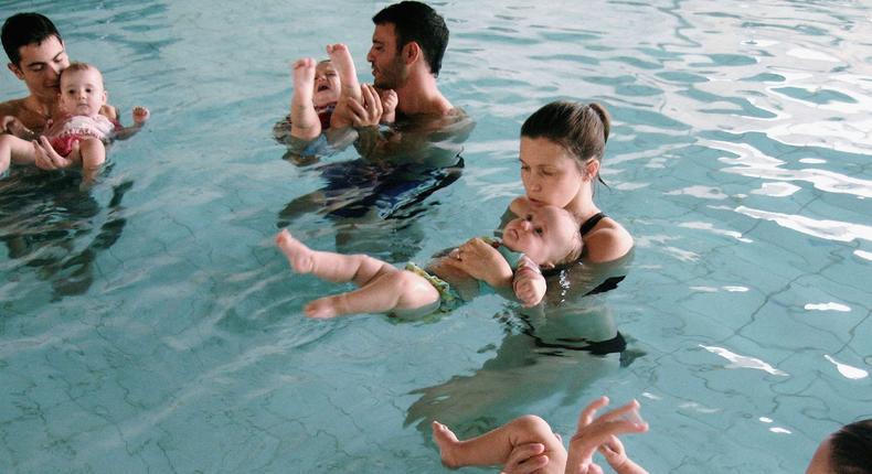 Toddlers explore the water with their mothers during a swimming class for babies at Lane Cove pool February 16, 2007 in Sydney, Australia.Getty Images/Ian Waldie