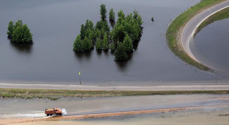 A truck drives along a flooded highway on the Mississippi River floodwaters on May 23, 2011 in Vicksburg, Mississippi.