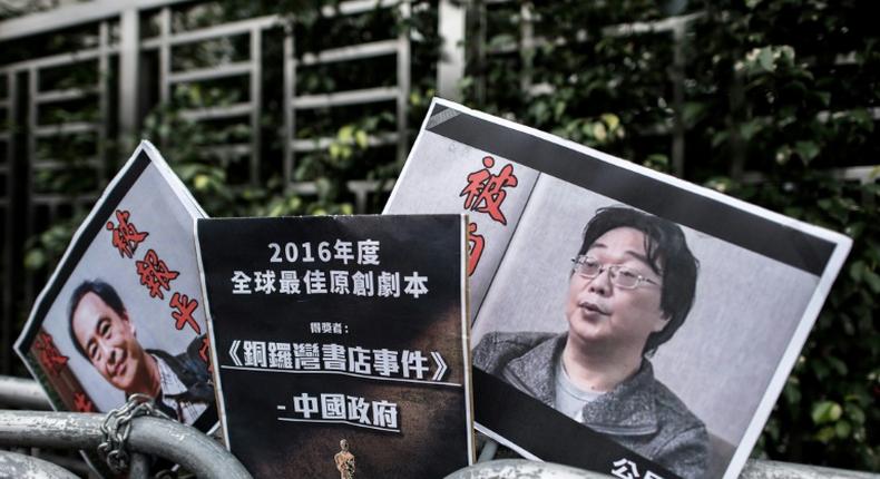 Placards showing missing bookseller Lee Bo (left) and his associate Gui Minhai (right) are left outside the China liaison office in Hong Kong following a January 2016 protest