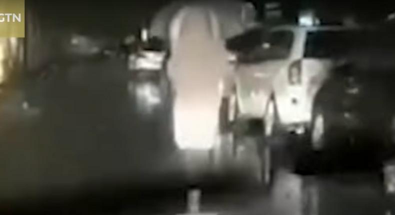 husband drives behind his wife as she walks to wuhan hospital at night