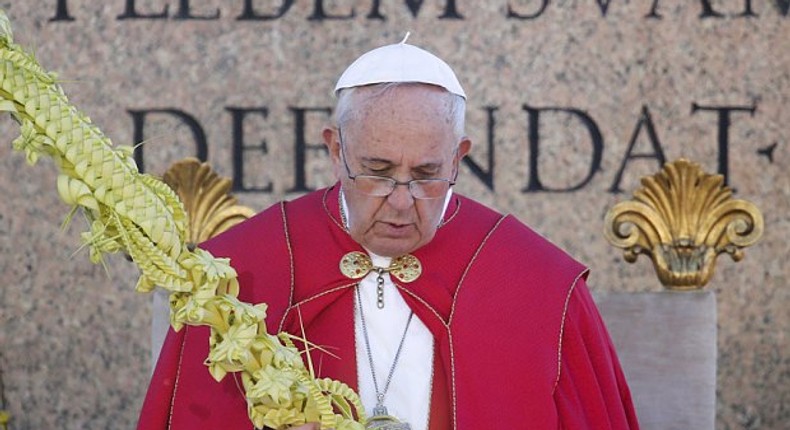 Pope Francis prays during Palm Sunday Mass 