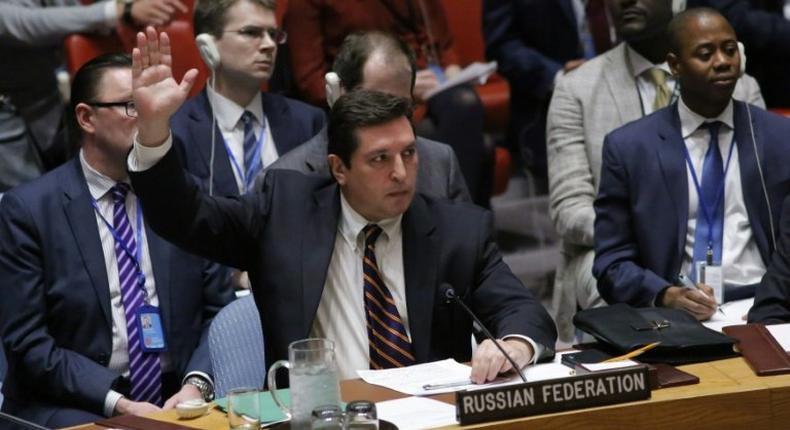 Russian Deputy Permanent Representative to the United Nations Vladimir Safronkov holds up his hand as he votes against a Draft resolution that condemns the reported use of chemical weapons in Syria at the Security Council on April 12, 2017