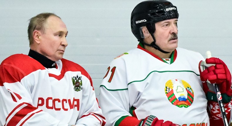 Russian President Vladimir Putin, left, and Belarusian President Alexander Lukashenko take a pause during the Night Hockey League match following their talks in Strelna, outside St. Petersburg, Russia, Wednesday, Dec. 29, 2021.